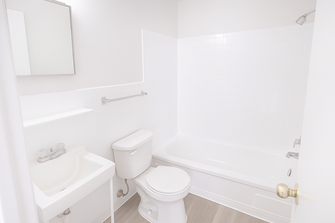 A white bathroom with a toilet, sink, and bathtub.