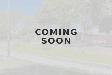 the coming soon sign in front of a building