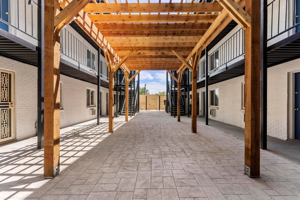 a building with a wooden roof and a walkway