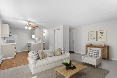 A living room with a white couch and a coffee table.