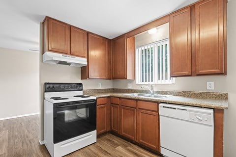 A kitchen with wooden cabinets and white appliances.
