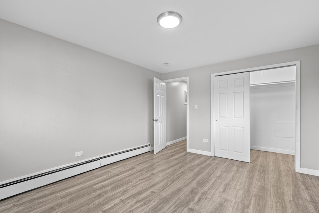 A room with a light on the ceiling and a white door.