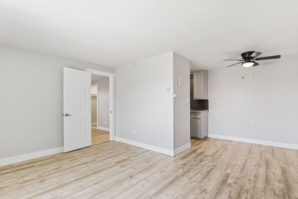 A room with a ceiling fan and a cabinet.