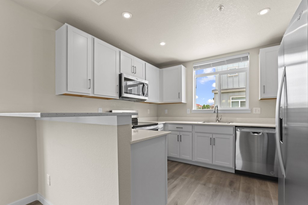 White Cabinetry And Appliances In Kitchen at The Townhomes at Pine Drive, Parker, CO, Colorado, 80138