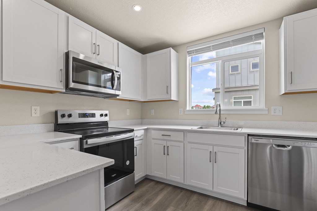 Modern Kitchen With White Cabinet at The Townhomes at Pine Drive, Parker, Colorado