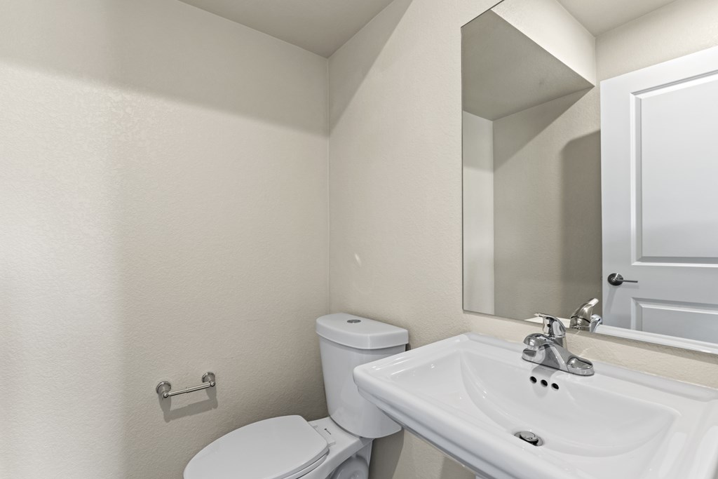 Bathroom with a toilet, sink and a tub at The Townhomes at Pine Drive, Parker