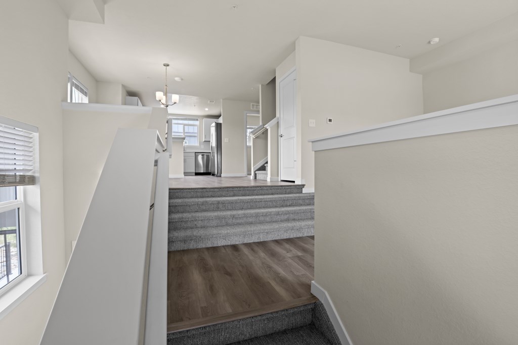 Grey carpeted staircase at The Townhomes at Pine Drive, Colorado