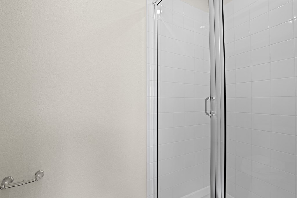 Modern bathroom with a glass shower door at The Townhomes at Pine Drive, Parker, Colorado