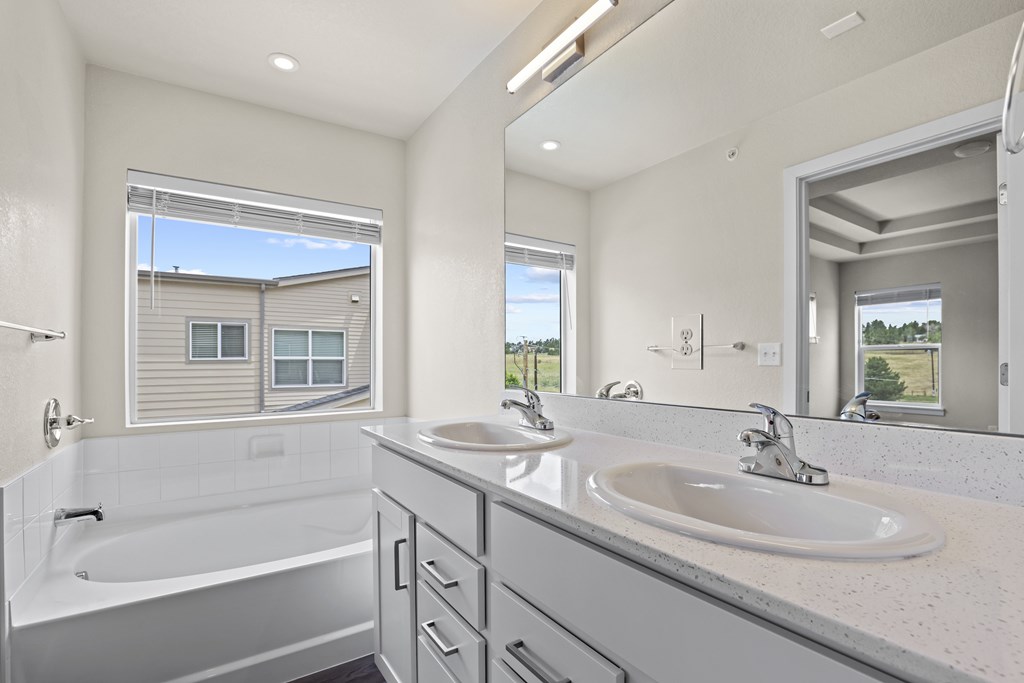 Modern bathroom with a large tub and double sinks at The Townhomes at Pine Drive, Parker, CO, Colorado