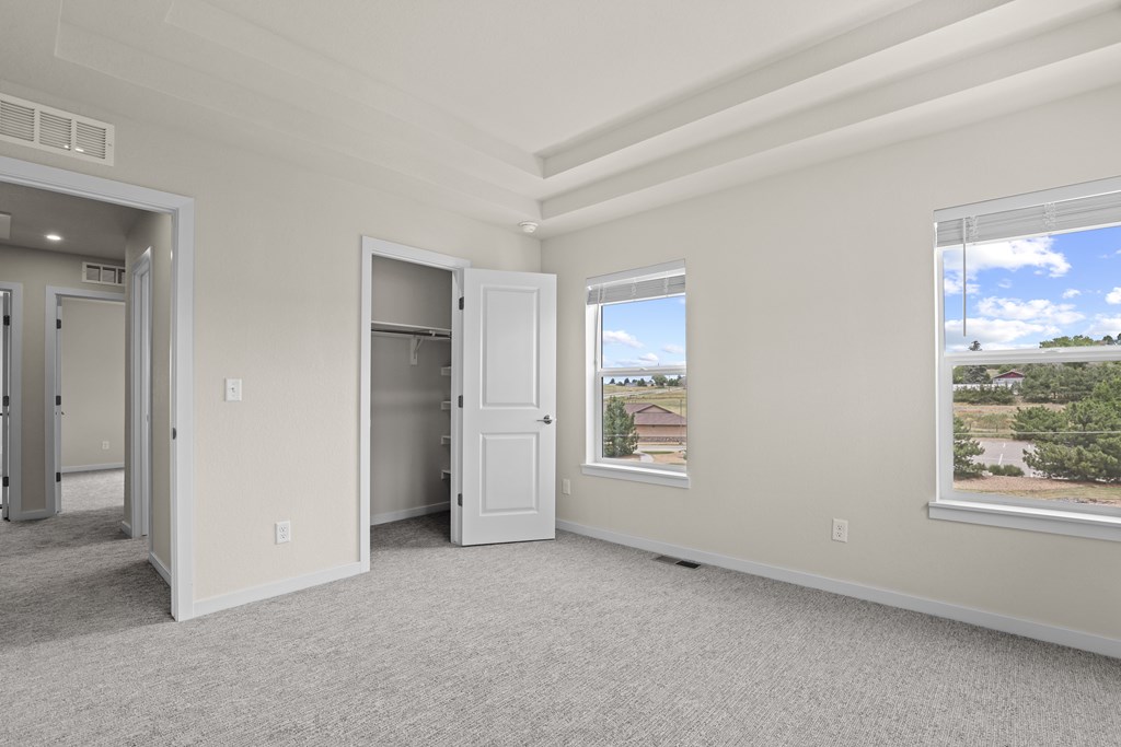 Room with a large window and a view of a residential area outside at The Townhomes at Pine Drive, Colorado, 80138