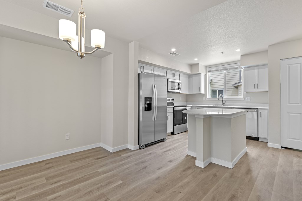 Kitchen With White Cabinetry And Appliances at The Townhomes at Pine Drive, Colorado, 80138