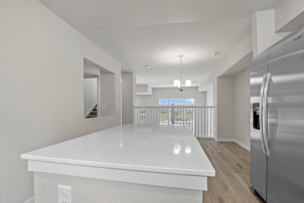 Modern kitchen with a white countertop and stainless steel appliances at The Townhomes at Pine Drive, Parker