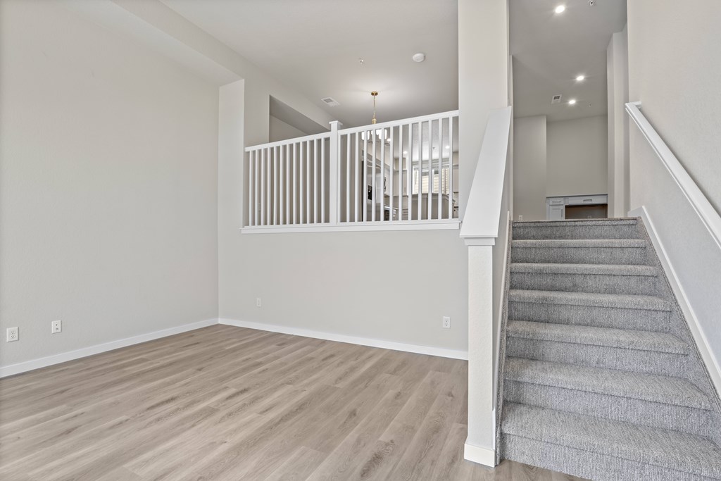 Staircase with a carpeted runner leads up to a second floor at The Townhomes at Pine Drive, Parker, CO, Colorado, 80138