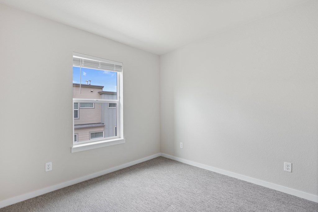 Room with a window and carpeted floor at The Townhomes at Pine Drive, Parker, 80138