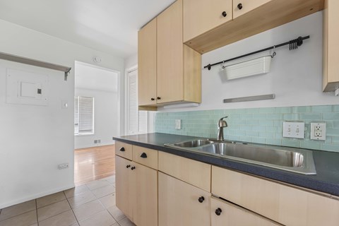 A kitchen with a sink and cabinets.