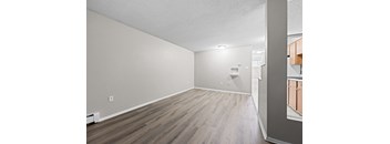 A room with wooden flooring and a white ceiling.