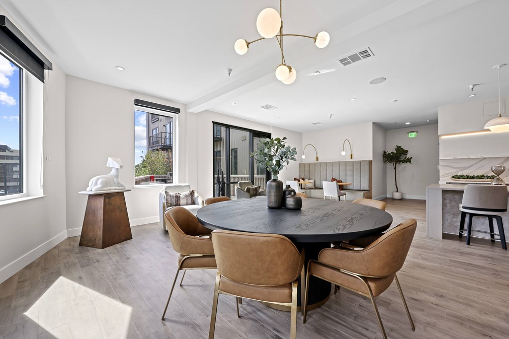 A modern dining room with a round table and chairs.