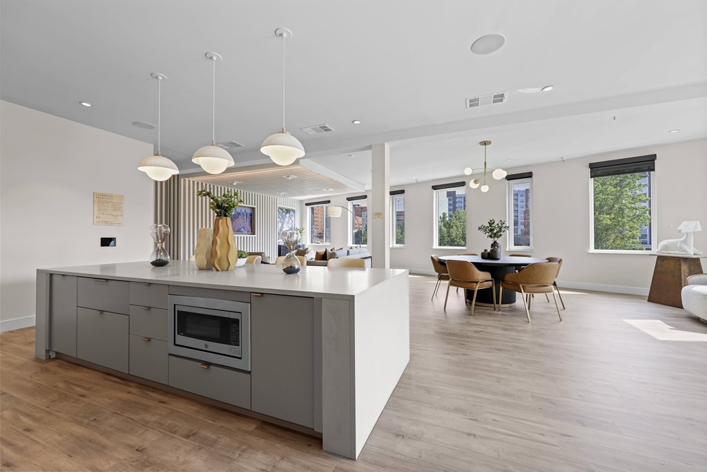 A modern kitchen with a dining table and chairs.