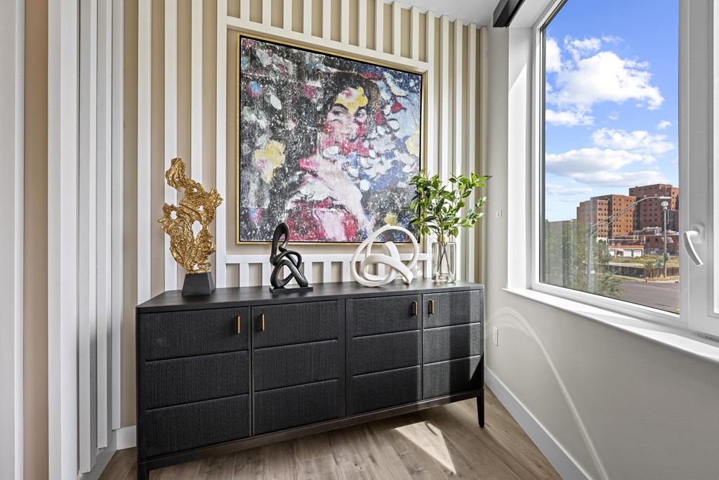 A black cabinet with a painting of a woman on it.