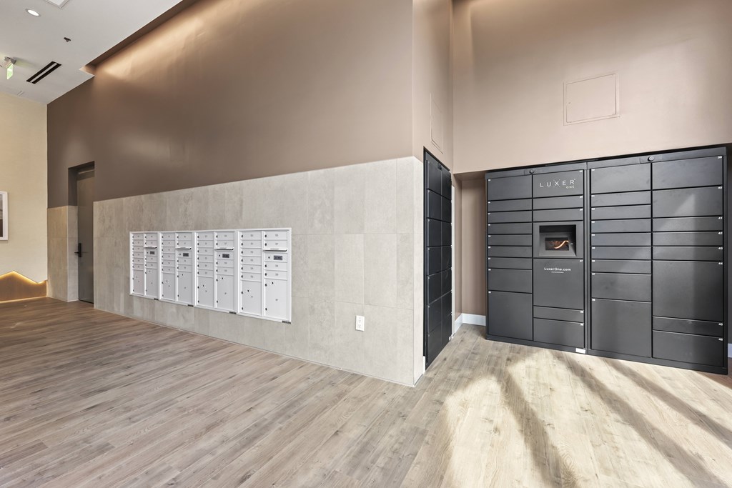 A room with a wooden floor and a wall with a calendar on it.