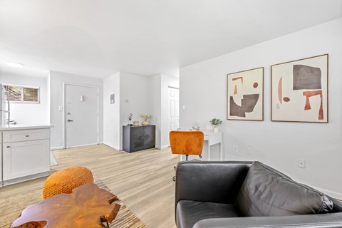A living room with a grey couch and a wooden table.