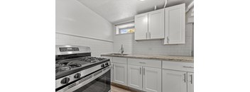 A kitchen with a stove and cabinets.