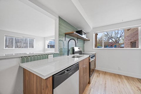 A kitchen with a white counter top and wooden cabinets.