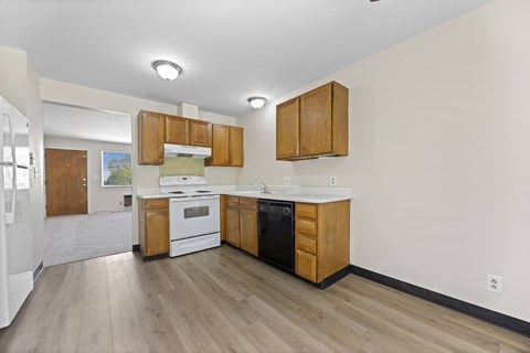 A kitchen with wooden cabinets and white appliances.