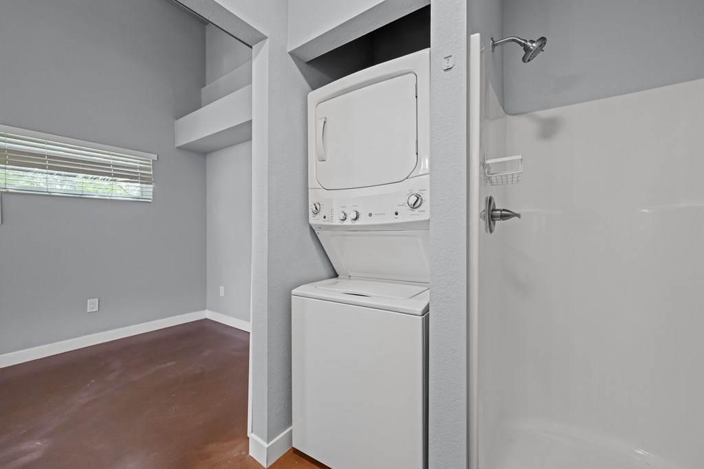 A white washing machine is in a bathroom.