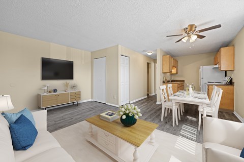 A living room with a white couch and a wooden coffee table.