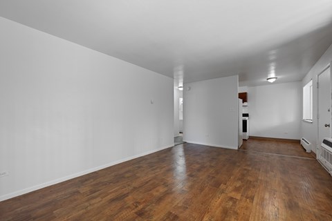 A room with wooden floors and white walls.