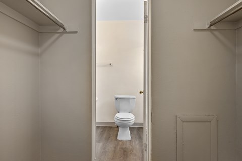 A white toilet in a small bathroom.