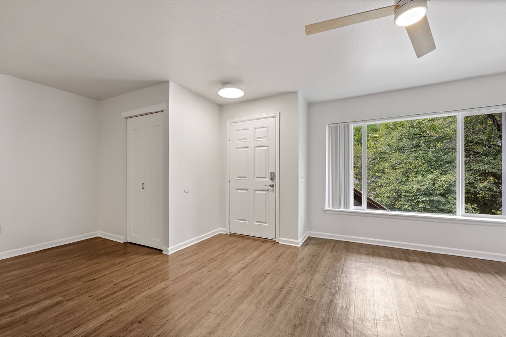 A room with a window and a door.