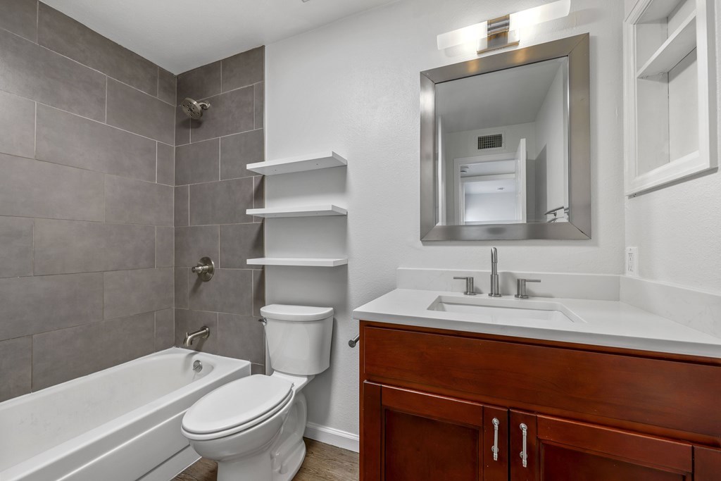 A bathroom with a toilet, sink, and bathtub.