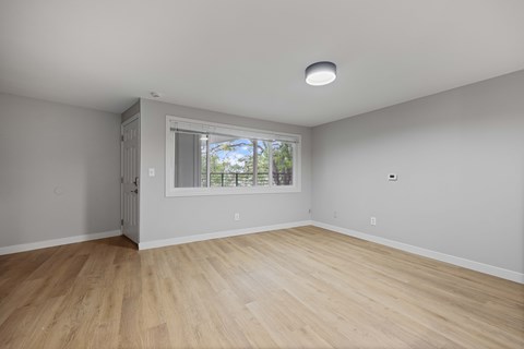 A room with a window and a sliding door.