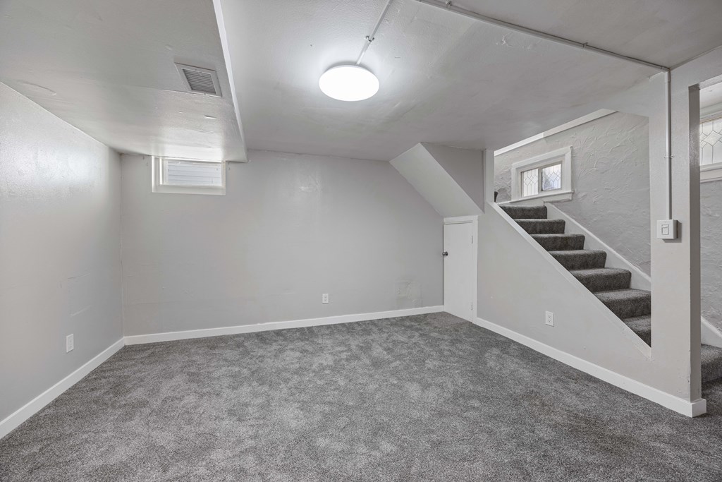 A room with a staircase leading to another room.