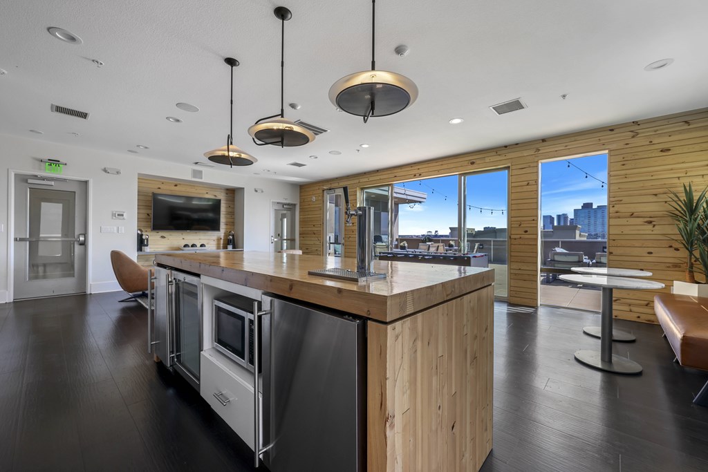 A modern kitchen with a wooden island and stainless steel appliances.