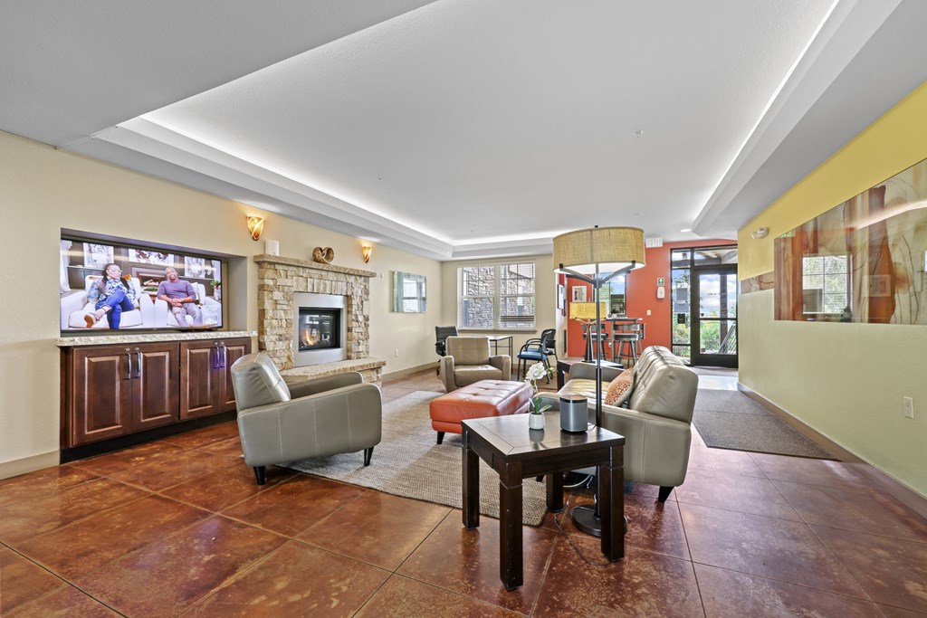 A living room with a fireplace and a television.
