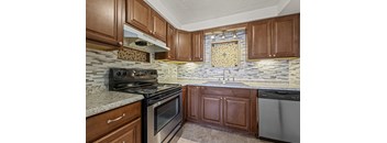 A kitchen with a stove top oven and a dishwasher.