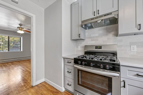 A kitchen with a stove and cabinets.
