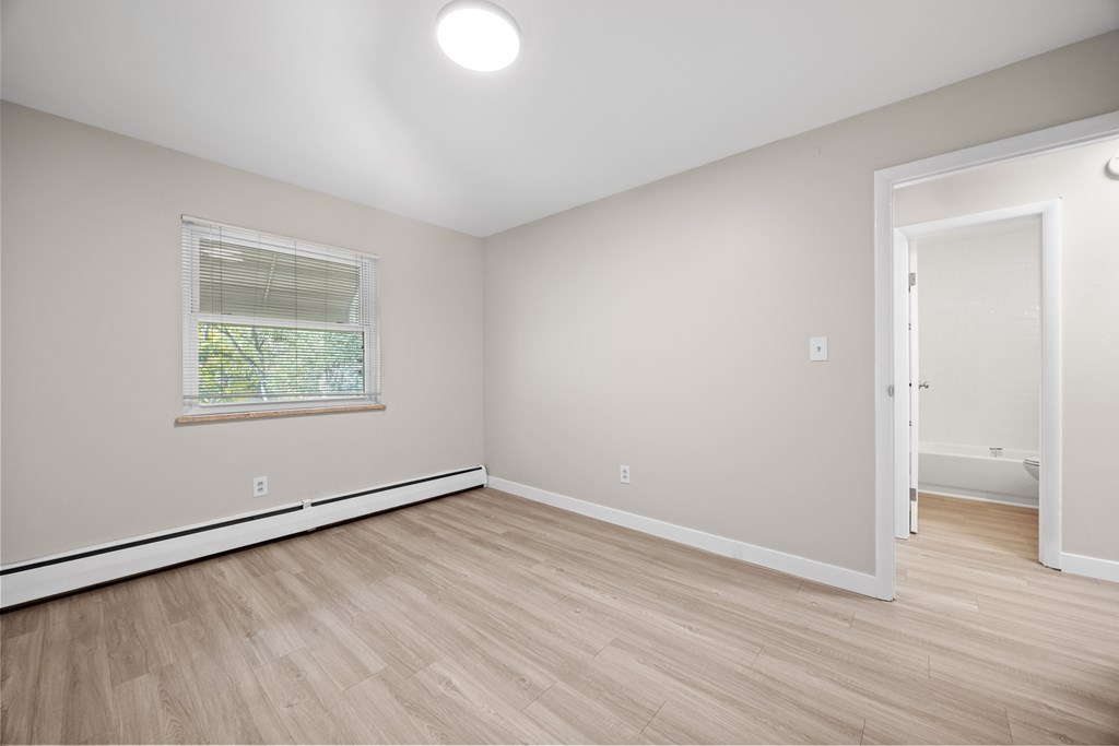 A room with a window and a door.