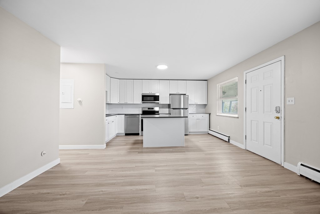 A kitchen with white cabinets and a central island.