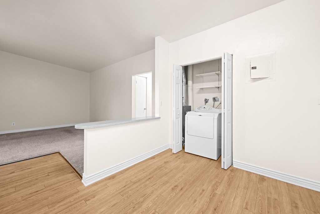 A white wall with a doorway leading to another room.