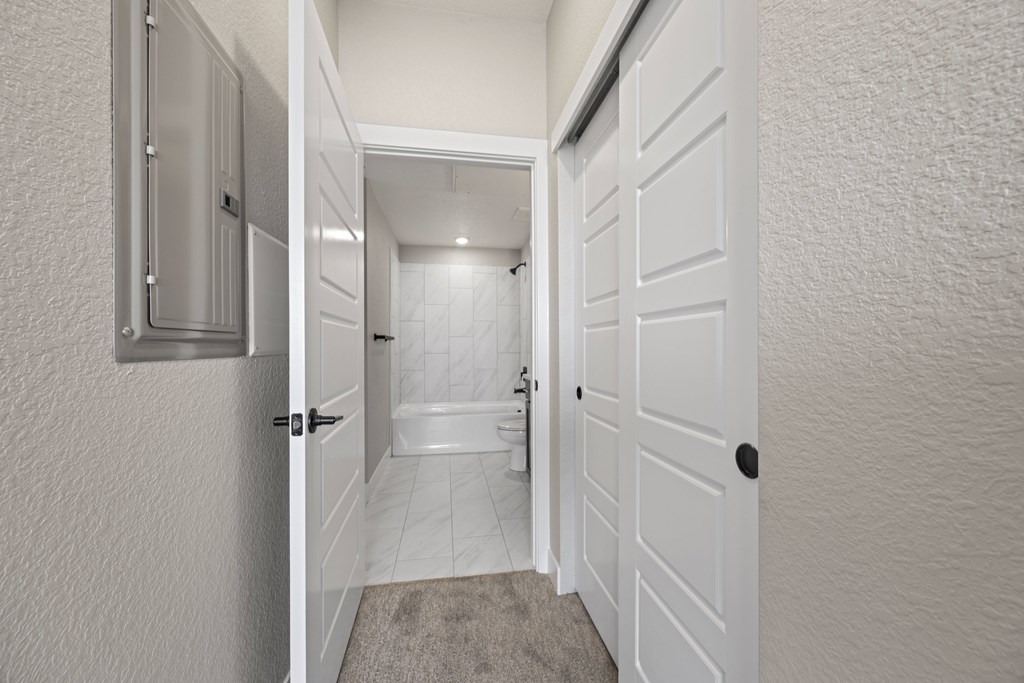 A white door is open to a bathroom.