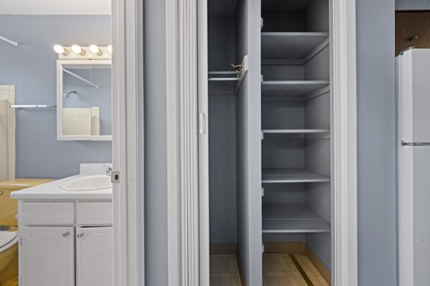 A white refrigerator with its door open in a room.