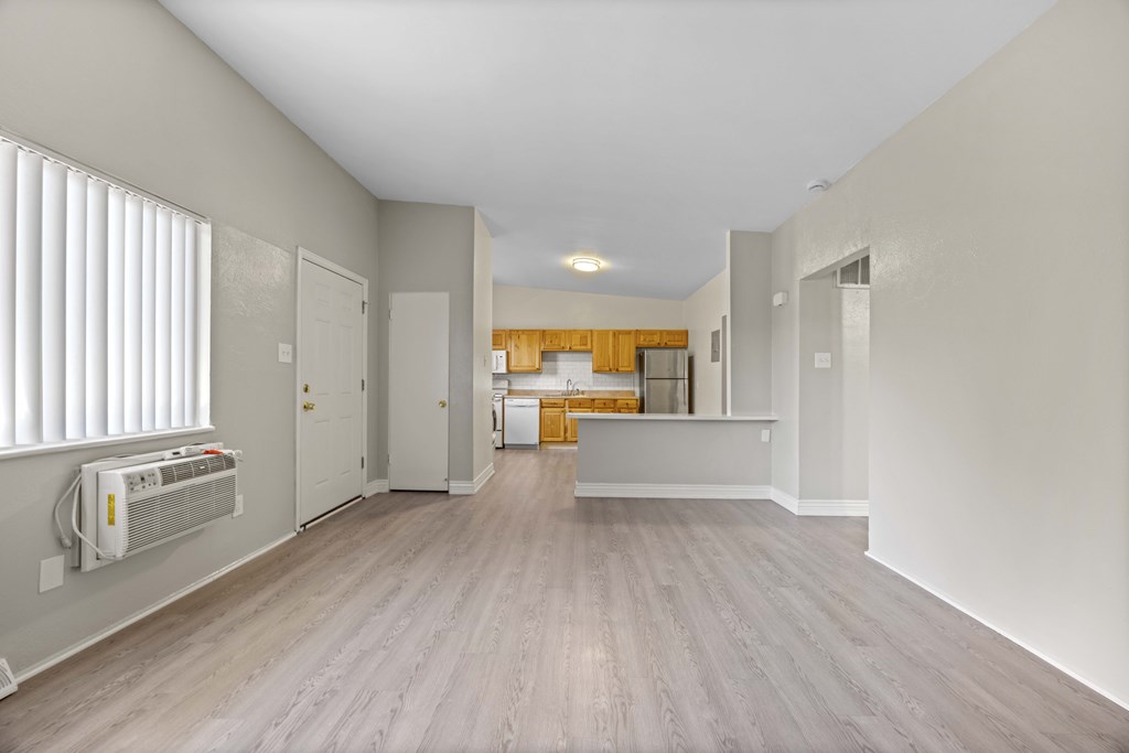 A room with a window and a wall-mounted air conditioner.