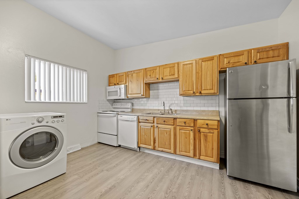 A kitchen with wooden cabinets and stainless steel appliances.