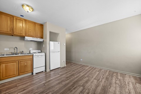 A kitchen with wooden cabinets and a white dishwasher.