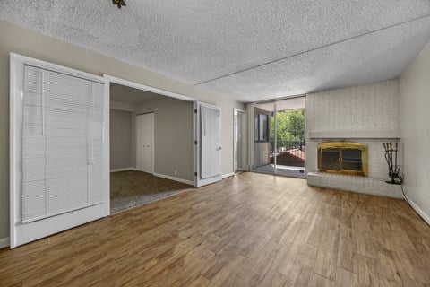 A room with a fireplace and sliding doors.