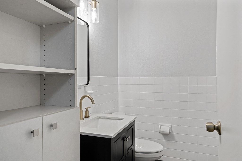 a bathroom with a sink and toilet in a 555 waverly unit